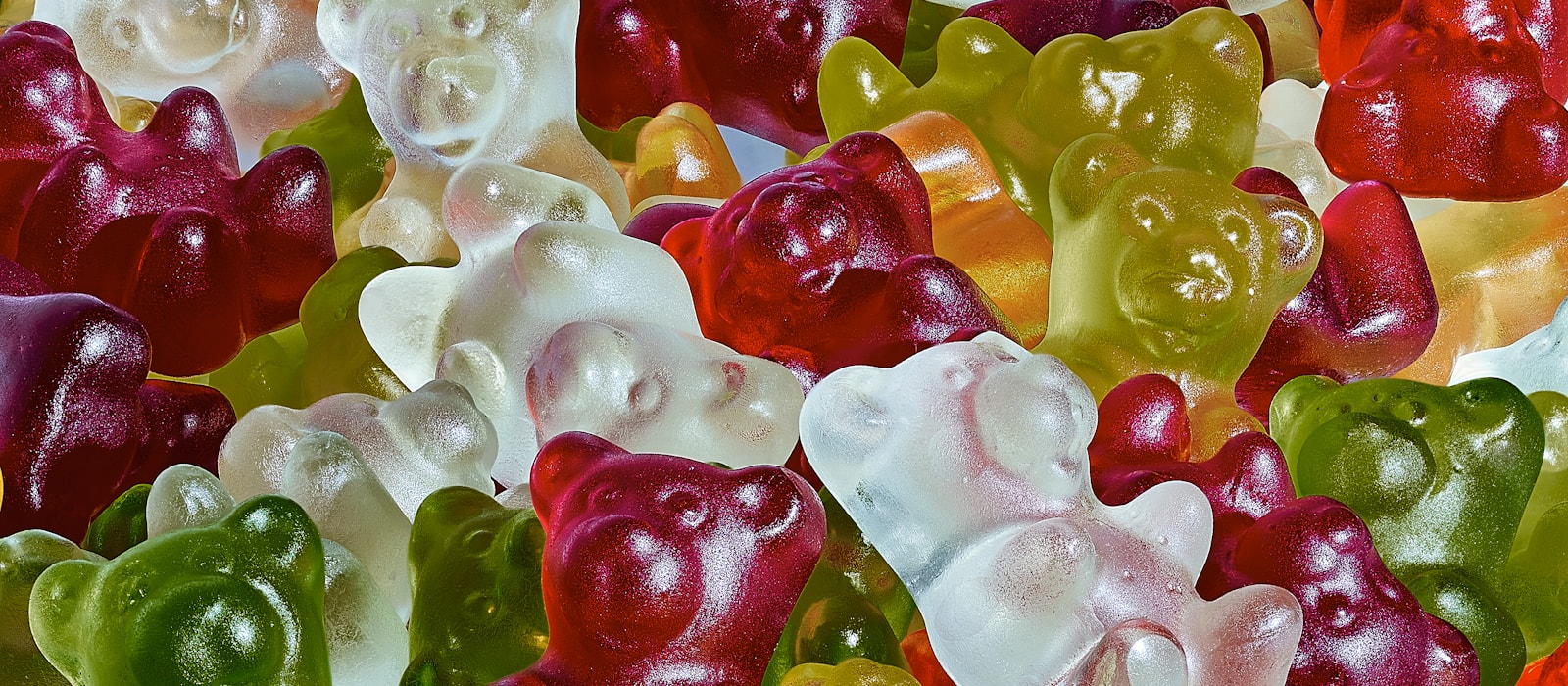 A pile of translucent gummy bears in many colours
