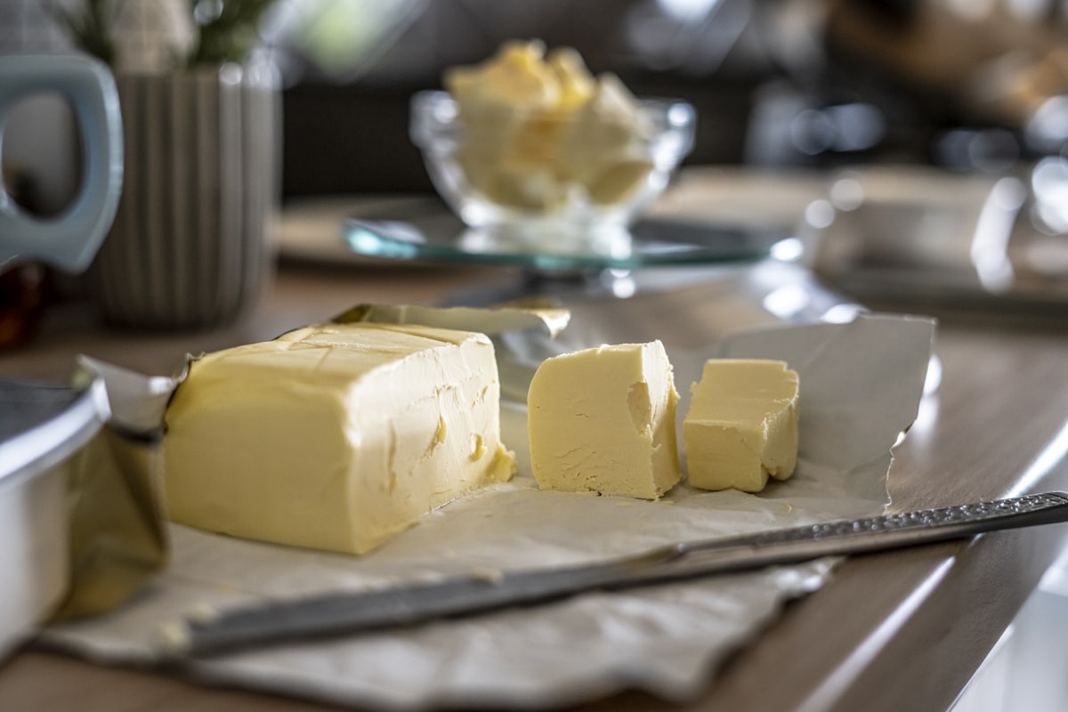 A block of golden cannabis-infused butter on parchment paper