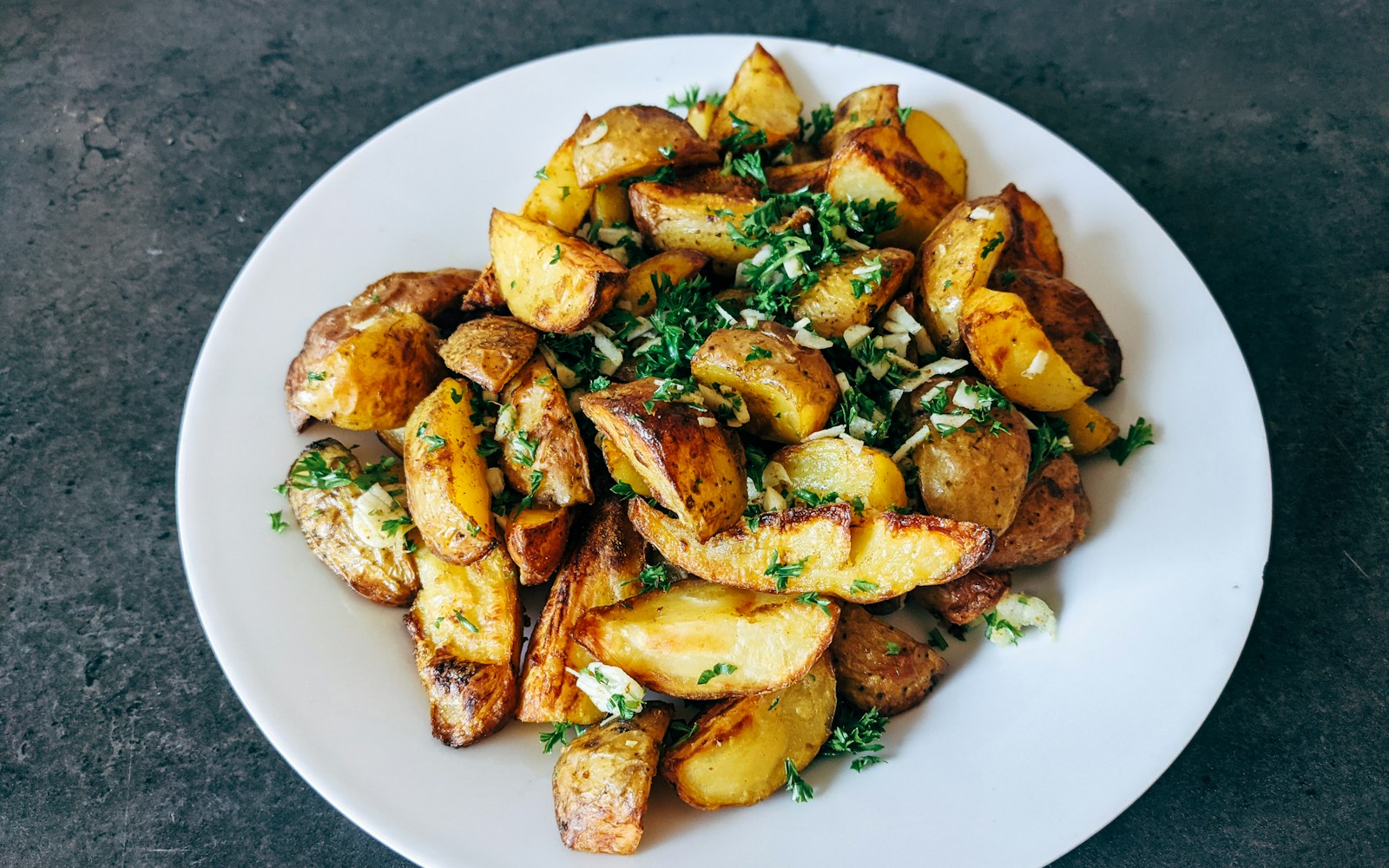 Crispy smashed baby potatoes glistening with herbed garlic butter