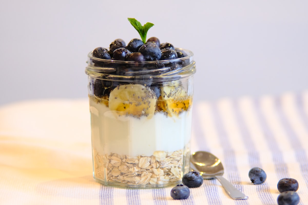 A jar of overnight oats topped with fresh blueberries