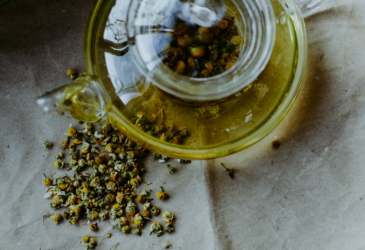 A clear mug of golden chamomile tea