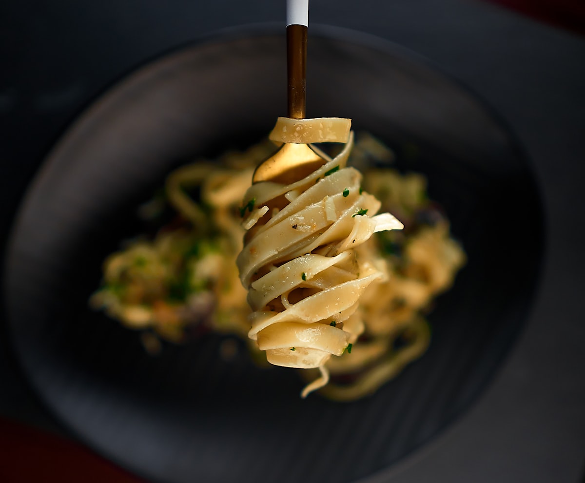 A bowl of buttery garlic pasta topped with parsley