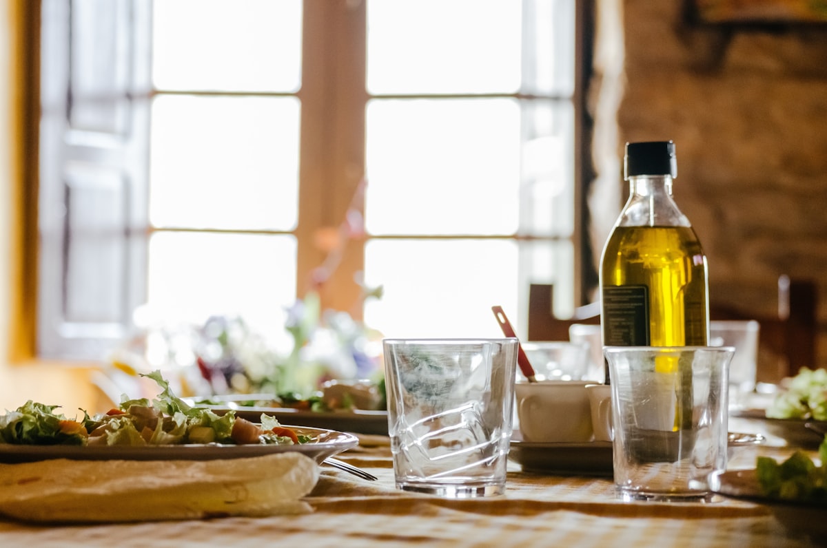 A glass cruet of green-gold cannabis-infused olive oil