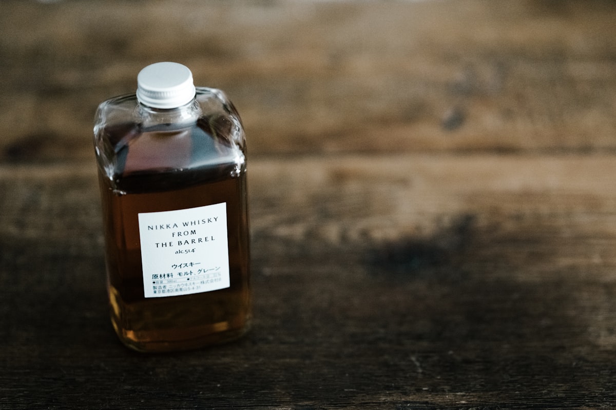A small glass bottle of syrup on a wooden counter