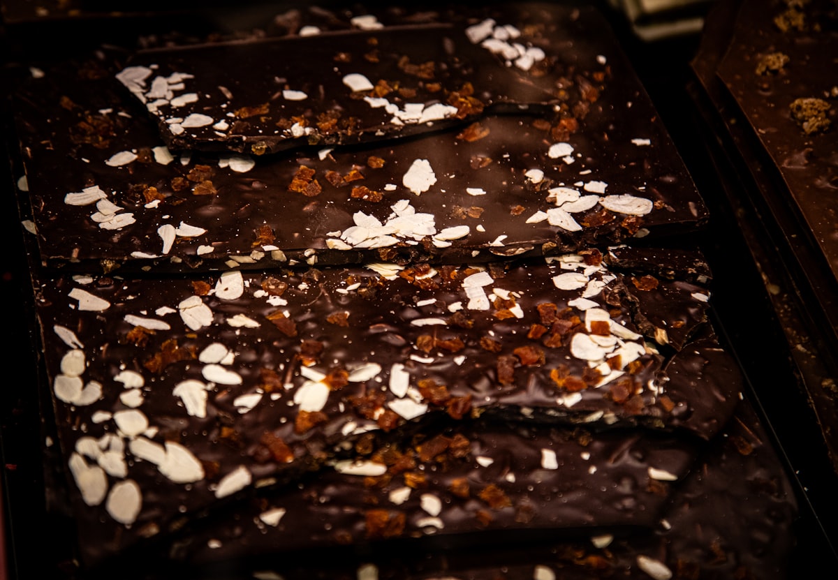 Broken squares of dark chocolate bark with almonds and flaky salt